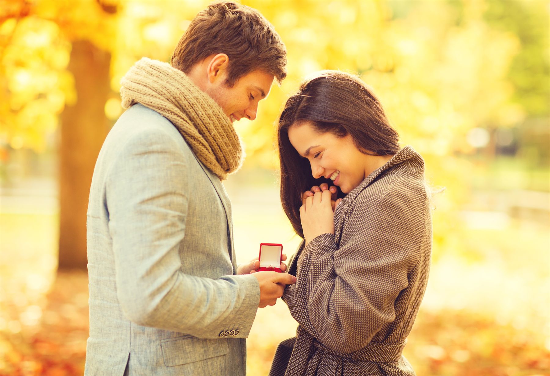 A couple sharing an engagement moment outdoors
